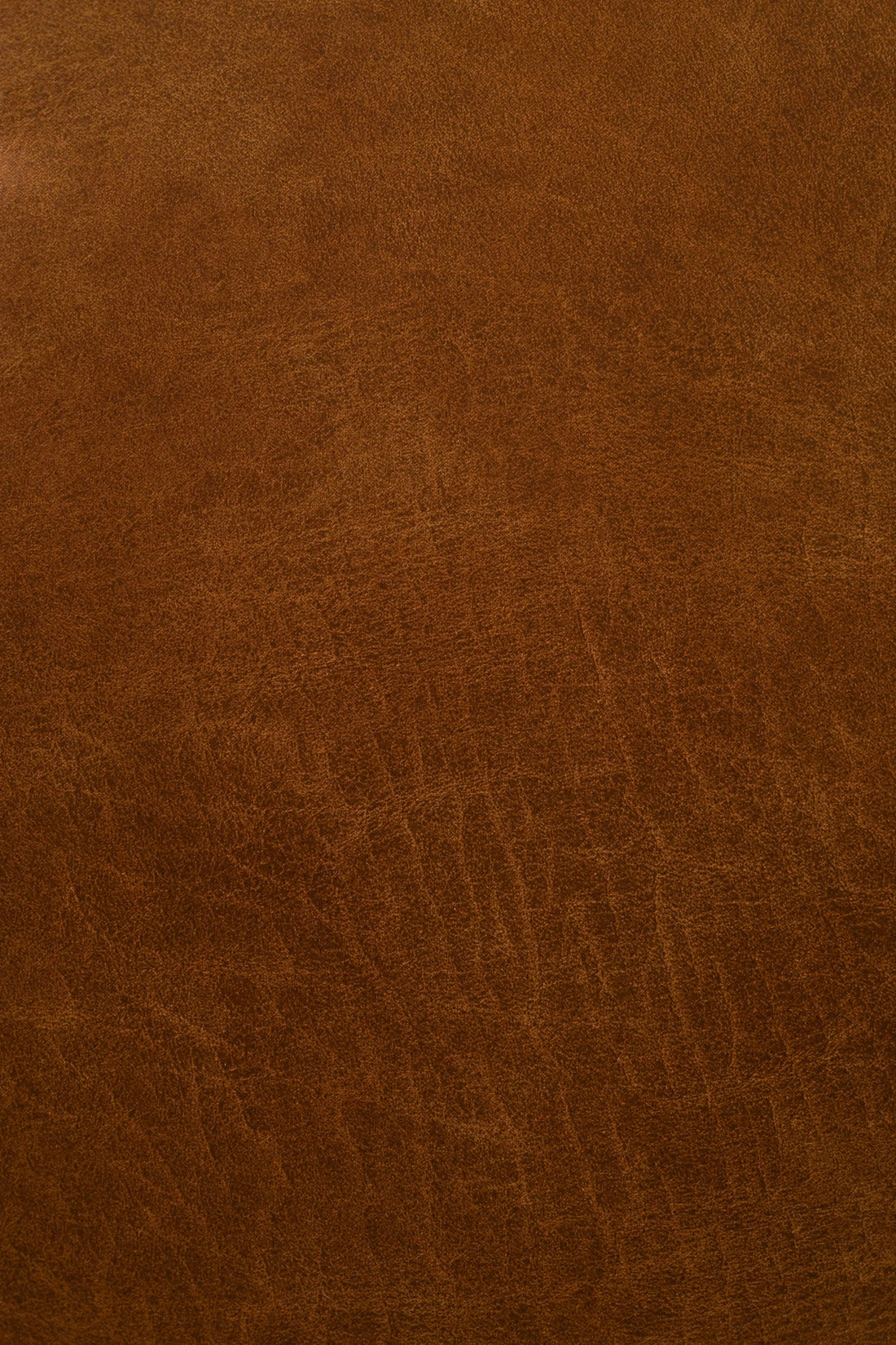 Close-up of rich brown leather showing natural texture and patina