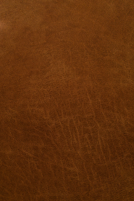 Close-up of rich brown leather showing natural texture and patina