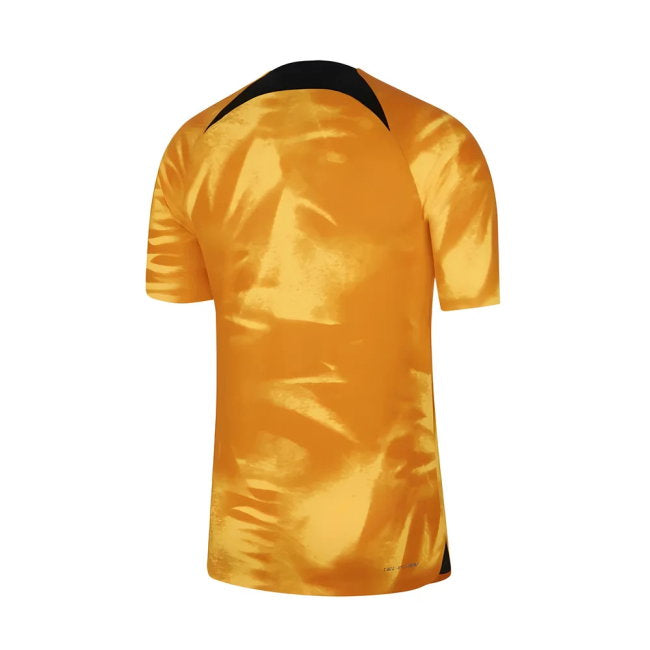 A short-sleeve athletic jersey shown from the back, featuring a metallic golden-yellow body with a contrasting black collar and small black details near the hem, set against a plain white background.