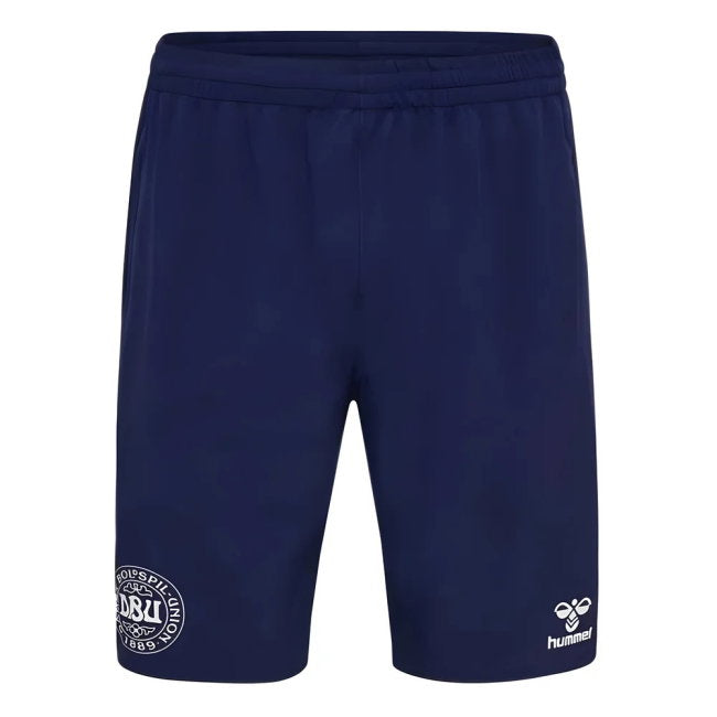Navy blue athletic shorts with an elastic waistband, featuring a white circular club crest on the left leg and the white Hummel logo on the right leg, shown against a plain white background.