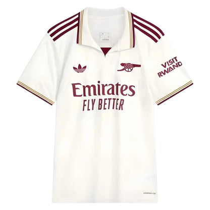 A white short-sleeve polo football shirt with maroon and gold trim, featuring the Arsenal club crest, Adidas logo, Emirates Fly Better sponsor text, and 'Visit Rwand' on the sleeve.