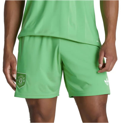 Green athletic shorts with a logo on a white background