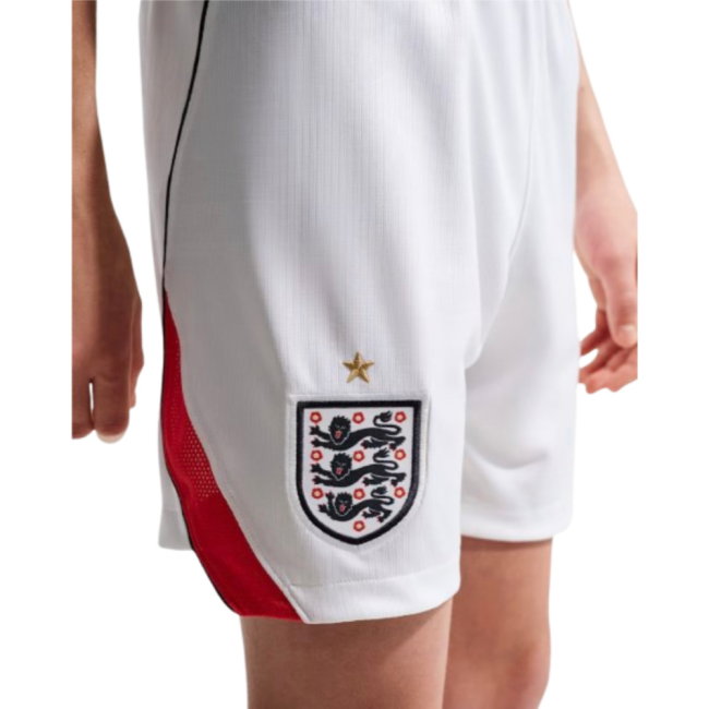 White England soccer shorts with a red side panel, featuring the embroidered Three Lions crest and a gold star on the left leg.