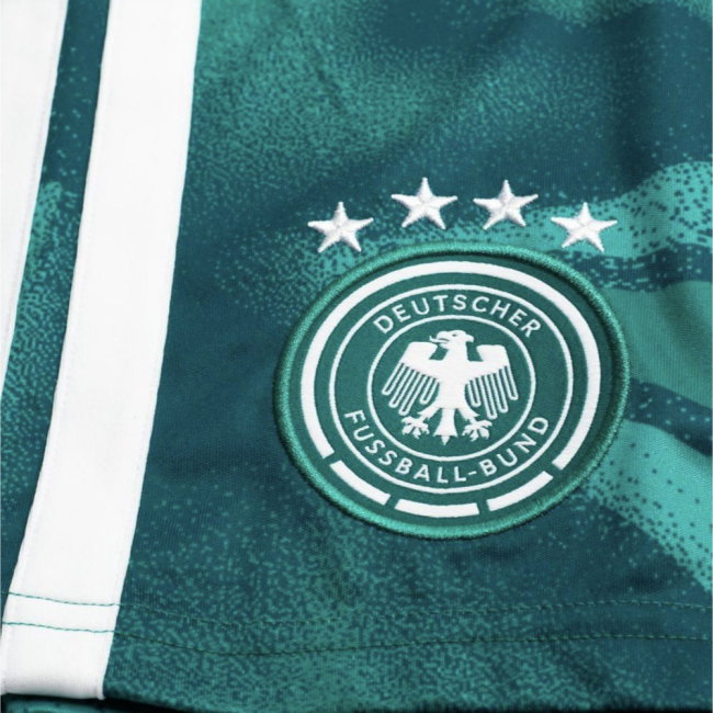 Close-up of a green sports jersey with a logo and text on a white background