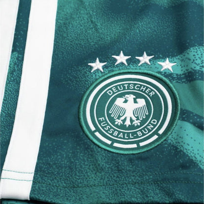 Close-up of a green sports jersey with a logo and text on a white background
