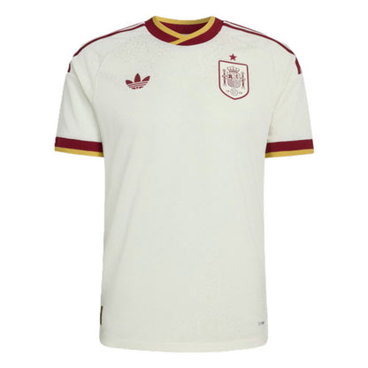 White Spain national football team home jersey by Adidas, featuring maroon and gold trim on the collar and sleeve cuffs, with the Adidas trefoil logo and Spain crest on the chest.