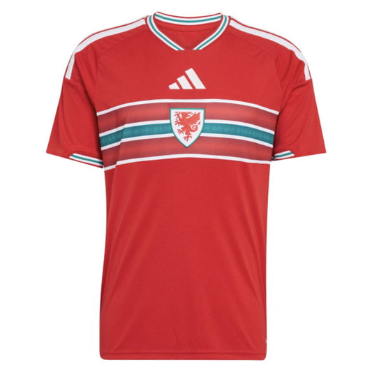 A red short-sleeve soccer jersey with white and teal stripes, featuring the white logo on the chest and the Wales national team crest in the center.