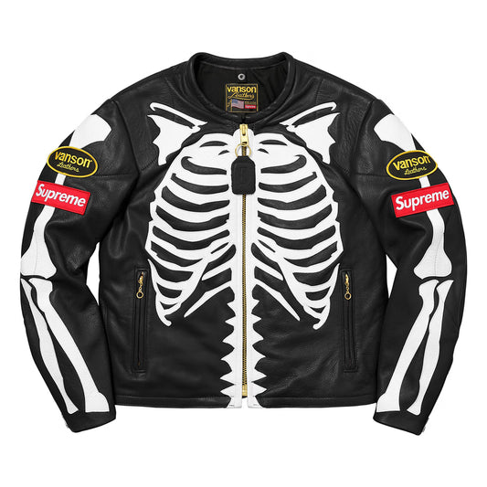 A black leather motorcycle jacket featuring a large white skeleton rib cage and arm bone graphic, with gold zippers and 'Vanson' and 'Supreme' patches on the sleeves.