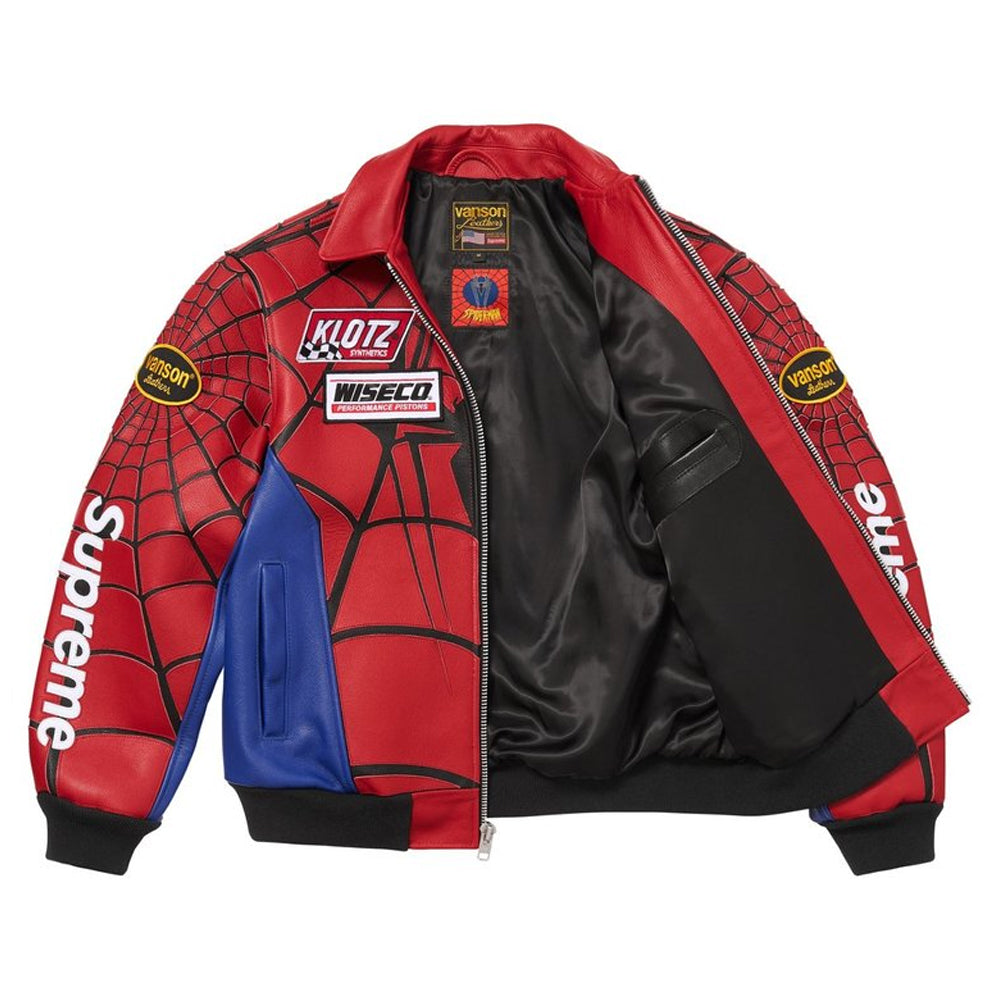A Supreme x Spider-Man themed bomber jacket featuring red and black web-patterned faux leather panels, a blue color-blocked side panel, and sponsor patches including Klutz, Wiseco, and Versace.