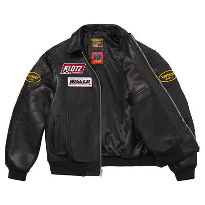 A black leather bomber jacket with quilted shoulder panels, a front zipper, and multiple racing sponsor patches including Klotz, Wiseco, and Verso on the chest and sleeves, shown against a plain white background.