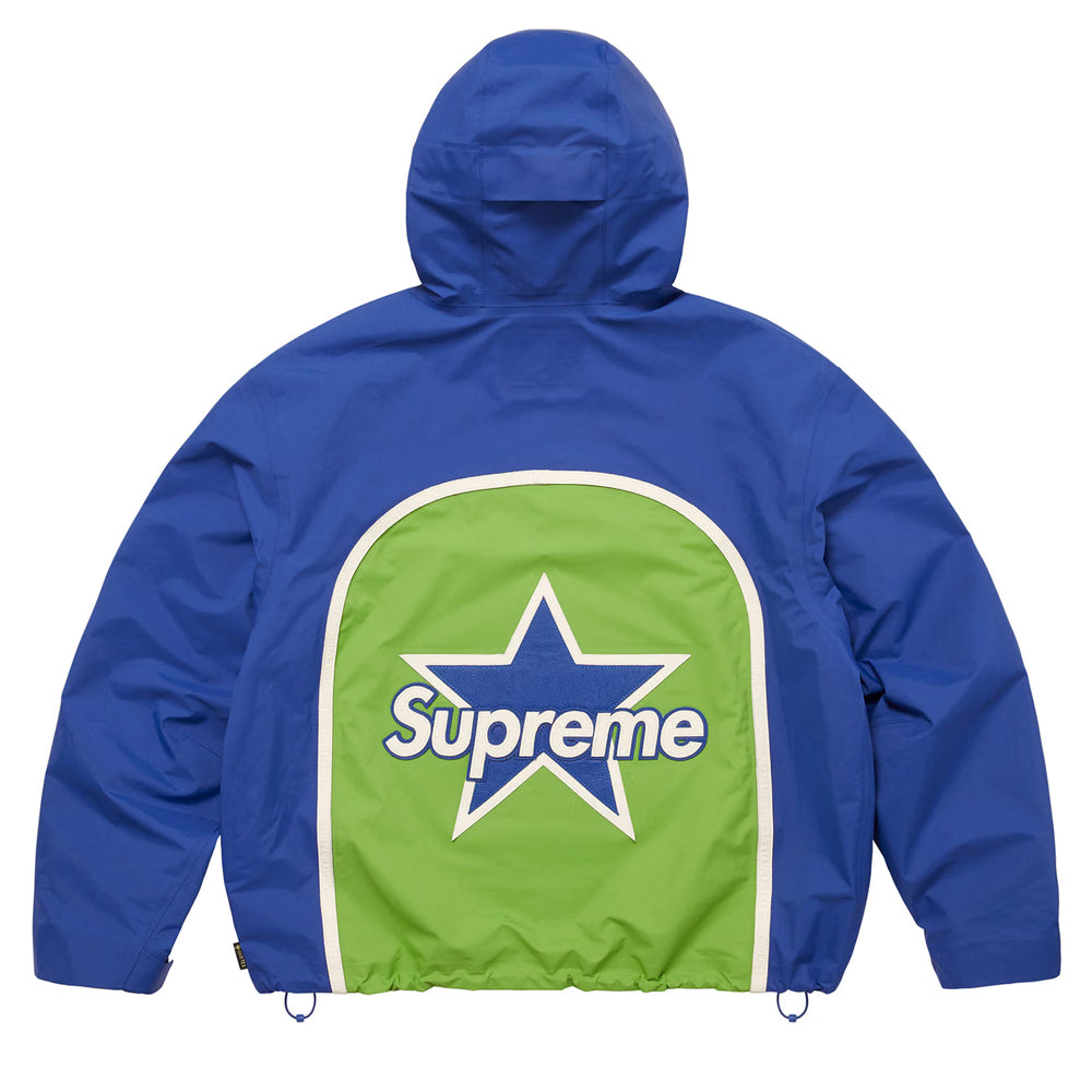 A blue hooded jacket shown from the back, featuring a large green panel with a white border and a central star containing the Supreme logo.